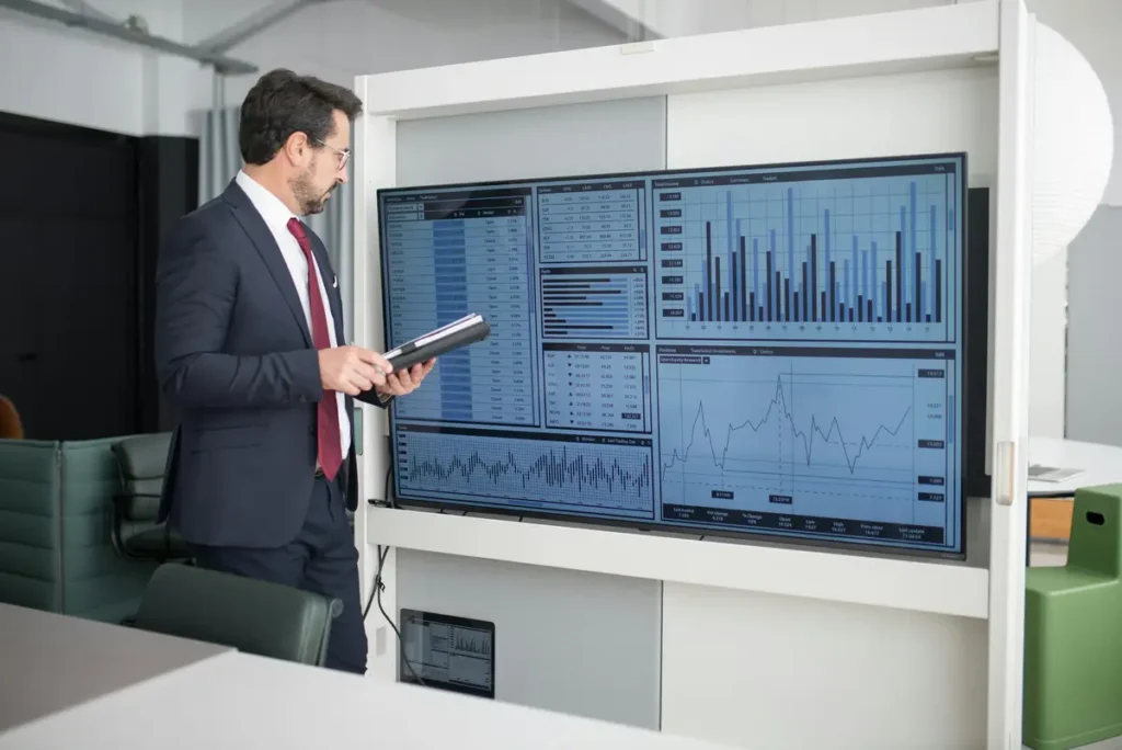 A professional investor in a bright, modern office looking at data, representing the rise of non-bank institutional capital in the receivables market.
