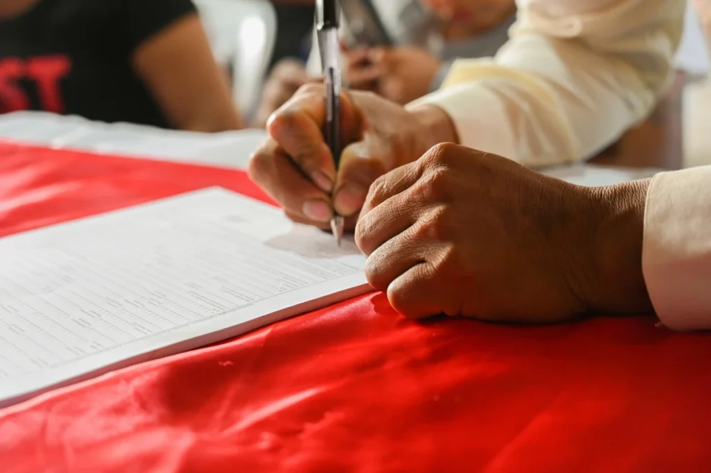 Close-up of a fountain pen signing a legal financial document and loan agreement to represent security interest enforcement.