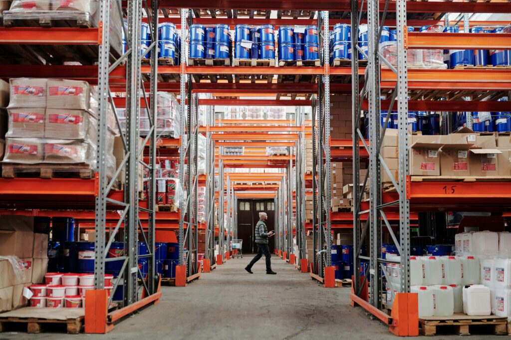 Interior of a large industrial warehouse with stored equipment and inventory representing specialized asset classes for recovery.