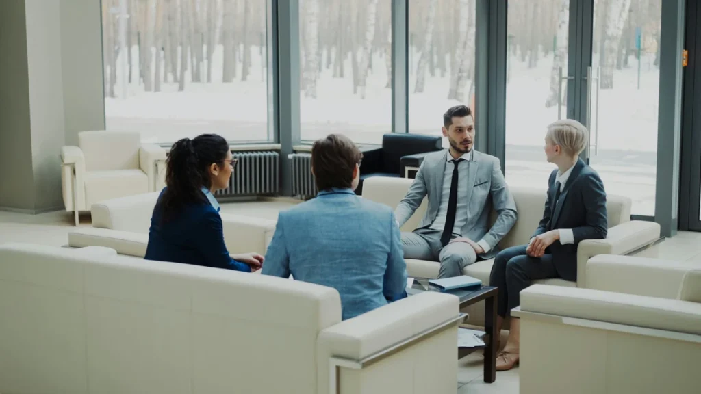 A group of business professionals in a boardroom discussing a secure transaction, representing buyer confidence and transparency.